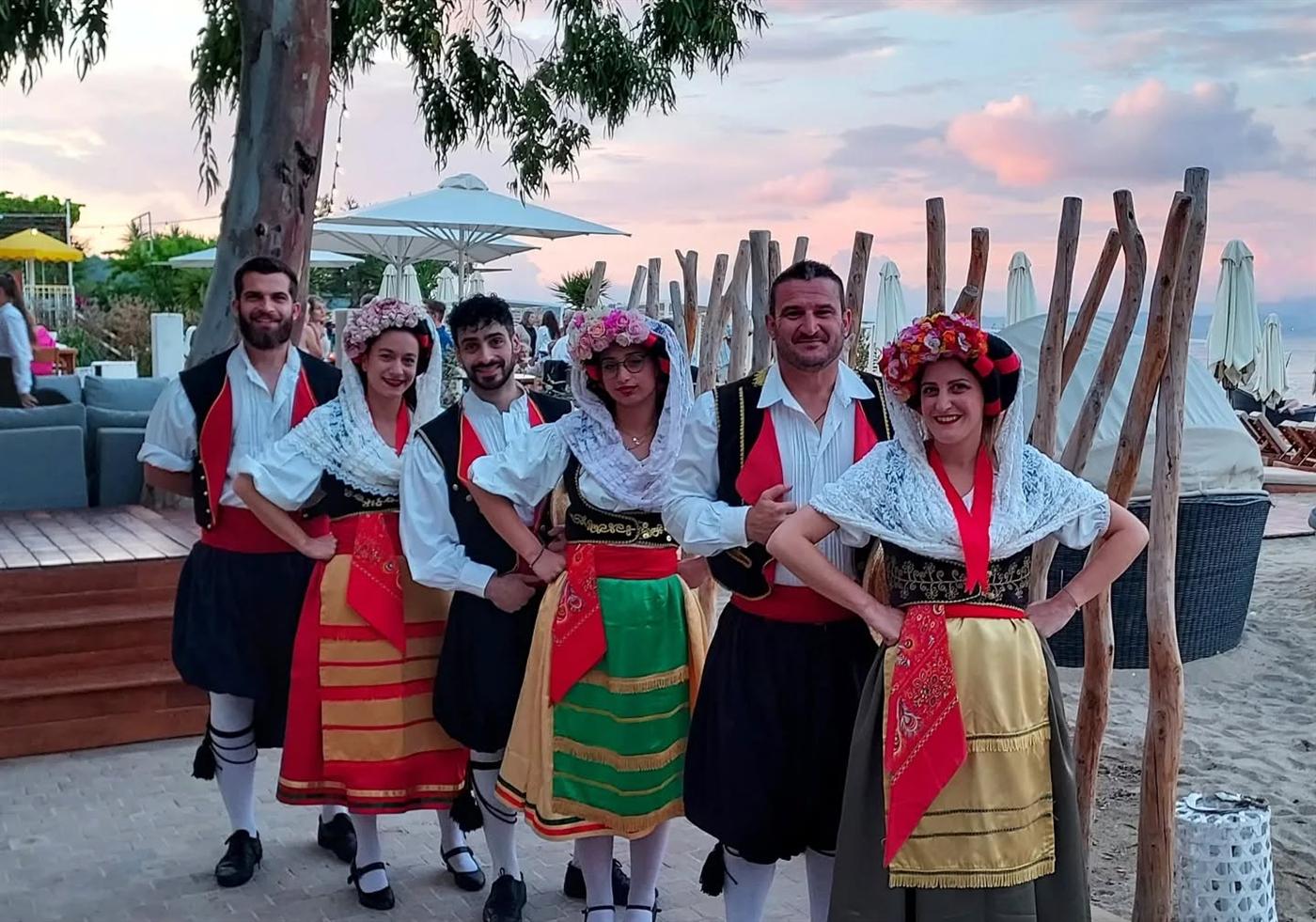 A group in Corfiot costume at dusk.